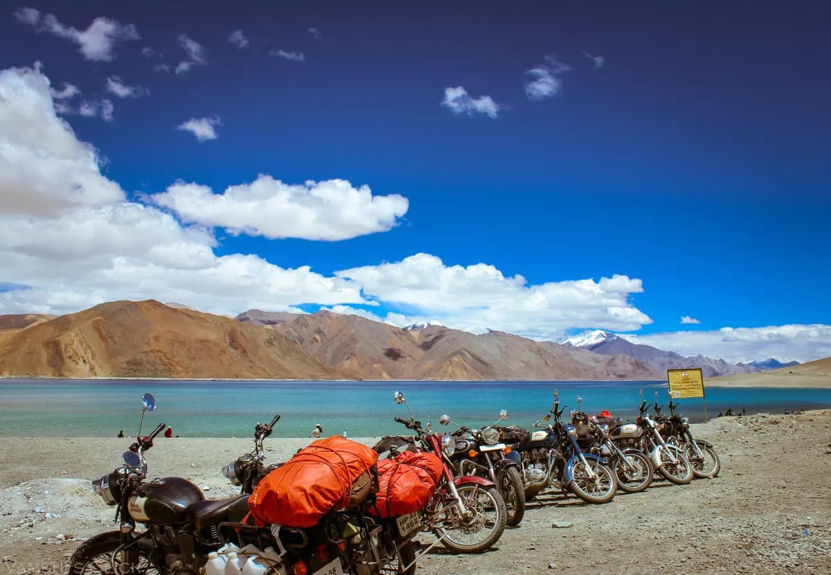 Pangong Lake with motorcycles parked on the shore, Ladakh